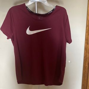 This is A Nike Dri-Fit athletic shirt! It is a maroon- red color!
